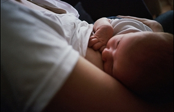 Mother breastfeeding newborn child